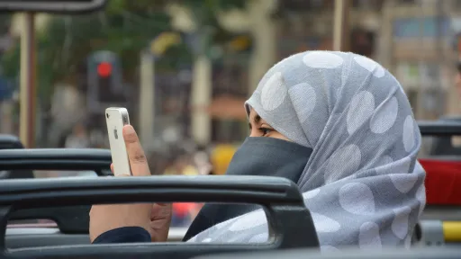 Muslim woman using her iphone